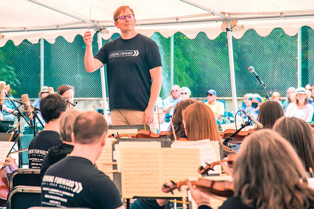 Olympia High School Orchestra teacher Joe Dyvig conducts the Olympia Symphony Orchestra during an outdoor performance at the Tenino Quarry Pool on Sunday.