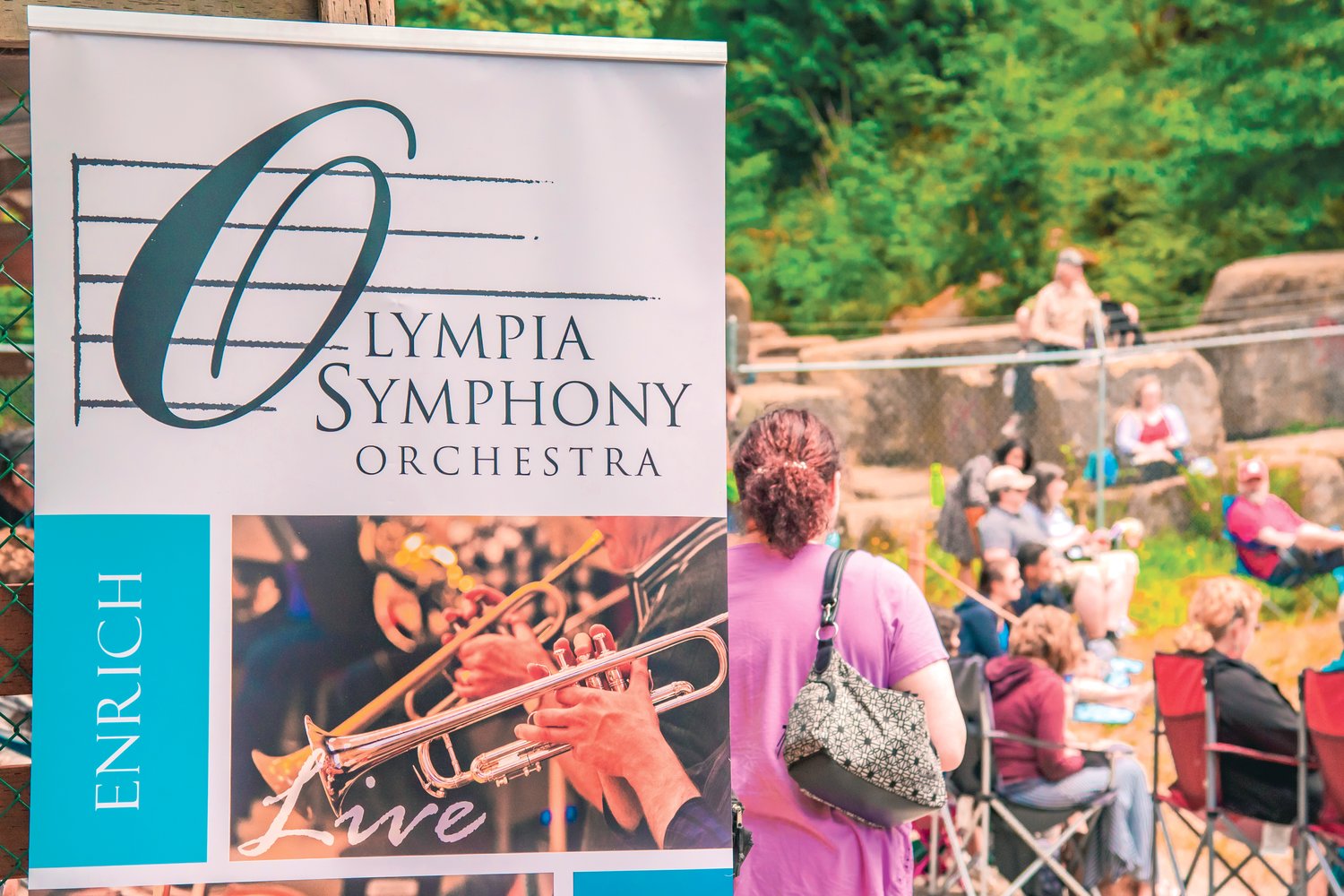 Attendees gather to listen as the Olympia Symphony Orchestra performs outside at the Tenino Quarry Pool on Sunday.