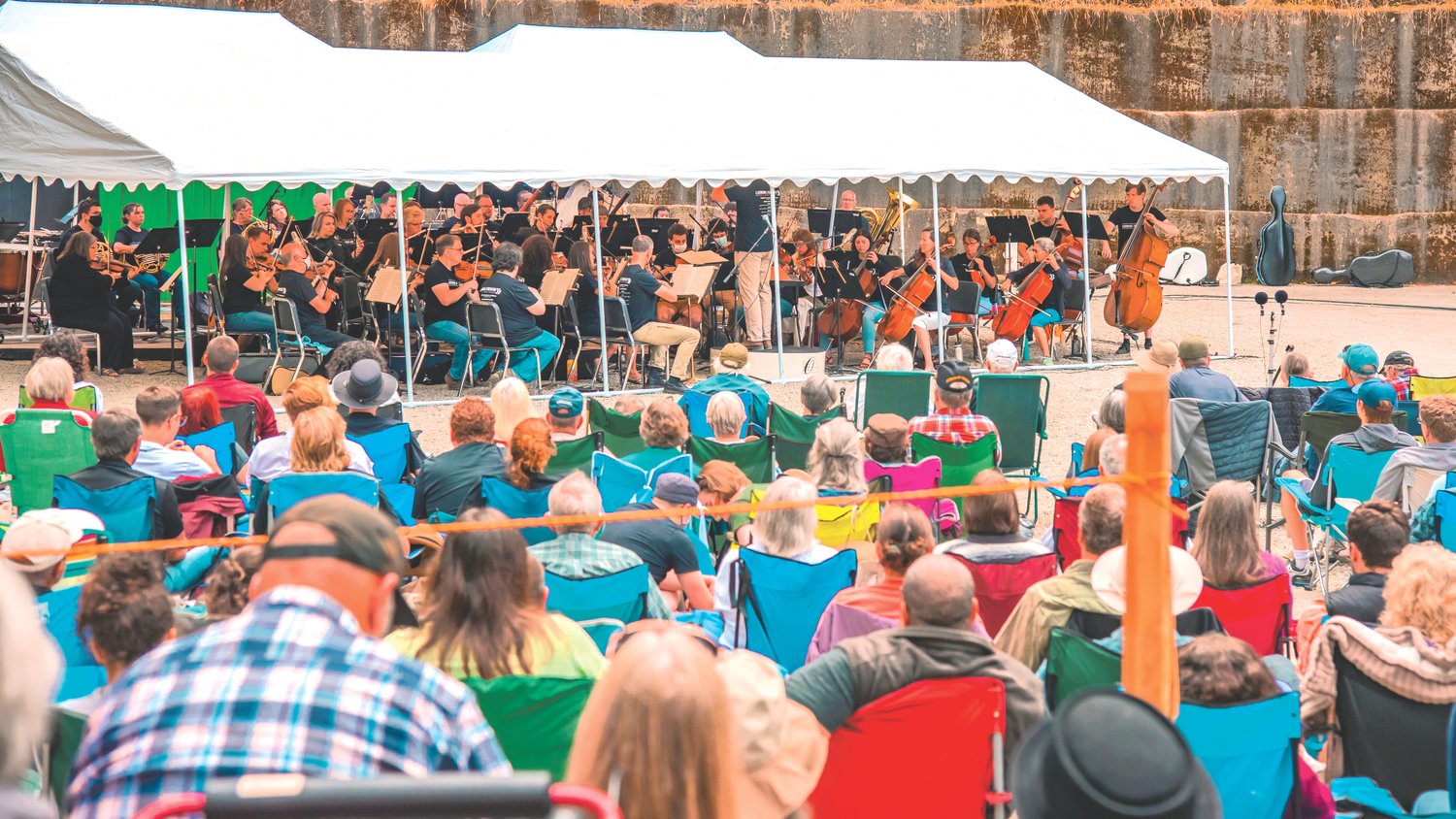 Instruments are played under tents as community members gather to listen as the Olympia Symphony Orchestra performs outside at the Tenino Quarry Pool Sunday afternoon.