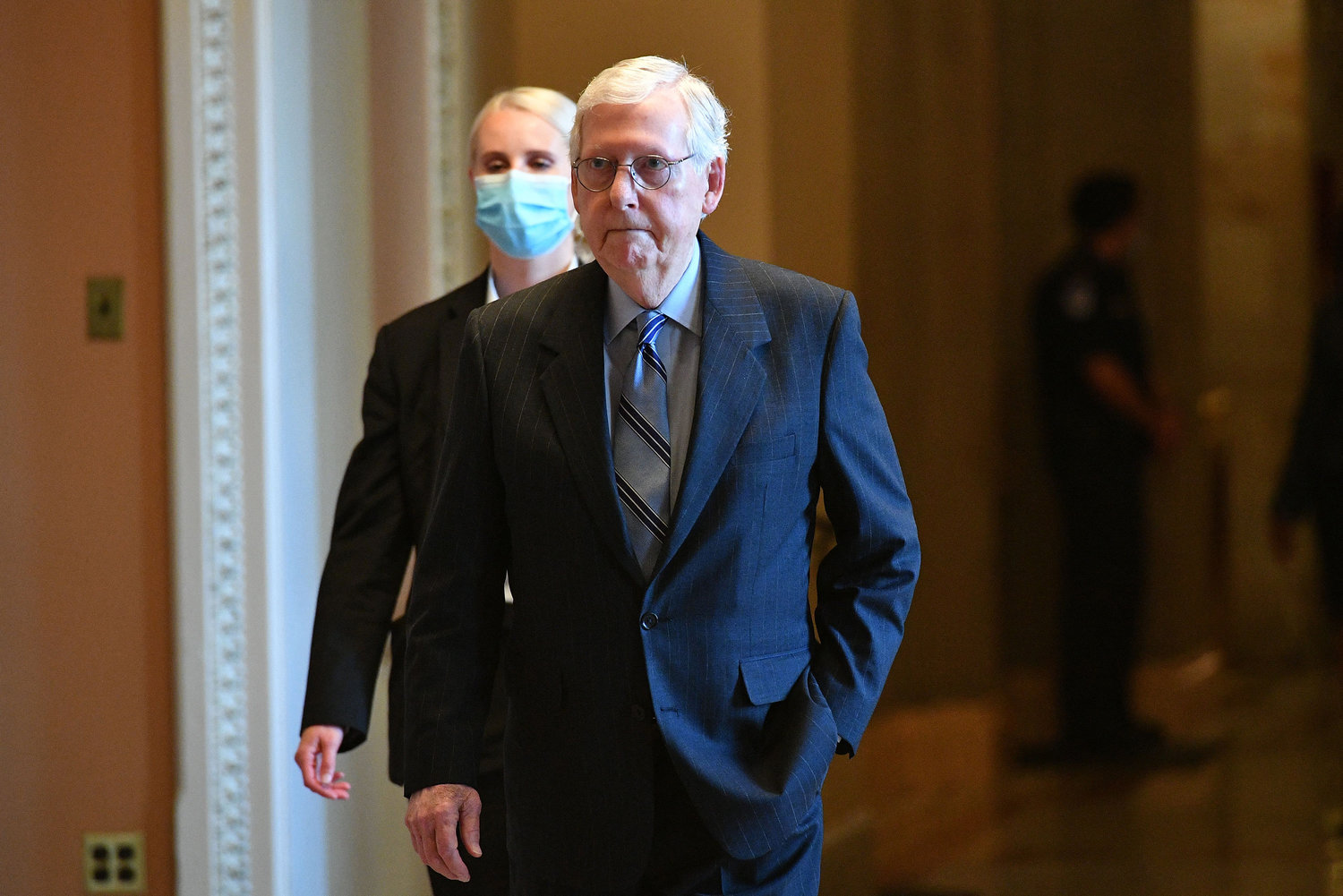 Senate Minority Leader Mitch McConnell, right, heads to chamber to cast his vote at the U.S. Capitol before a Senate vote on the passage of a massive infrastructure plan in Washington, D.C., on Tuesday, Aug. 10, 2021. (Mandel Ngan/AFP/Getty Images/TNS)