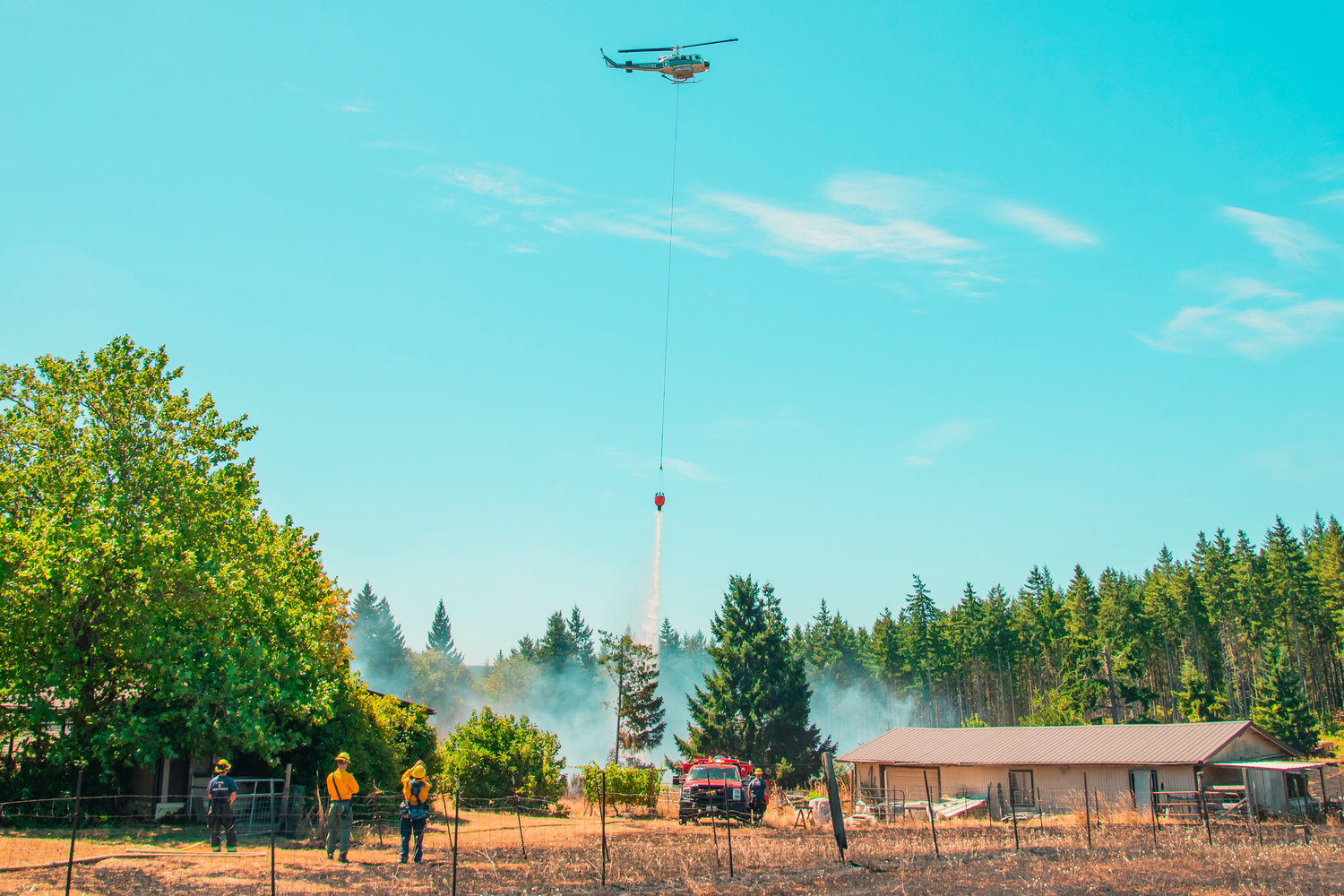 A helicopter dumps water on a hot zone as crews respond to the scene of Brown Road East in 2021.