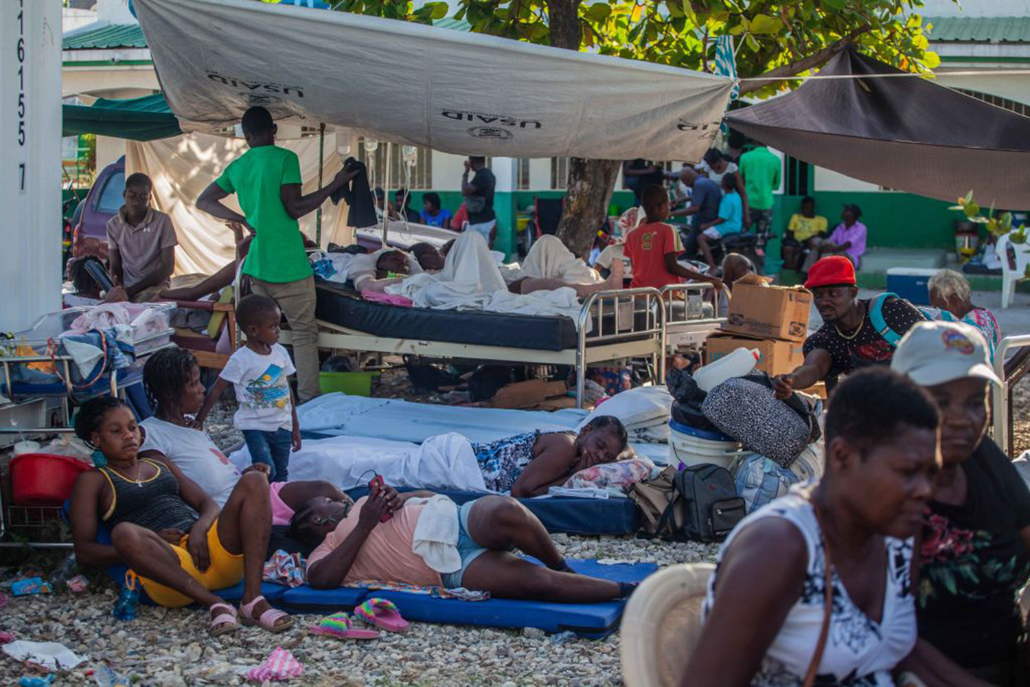 Haitians rest outdoors after a 7.2-magnitude earthquake on August 15, 2021 in Les Cayes, Haiti. Rescue workers have been working among destroyed homes since the quake struck on Saturday and so far there are 1,297 dead and 5.700 wounded. The epicenter was located about 100 miles west of the capital city Port-au-Prince. (Richard Pierrin/Getty Images/TNS)