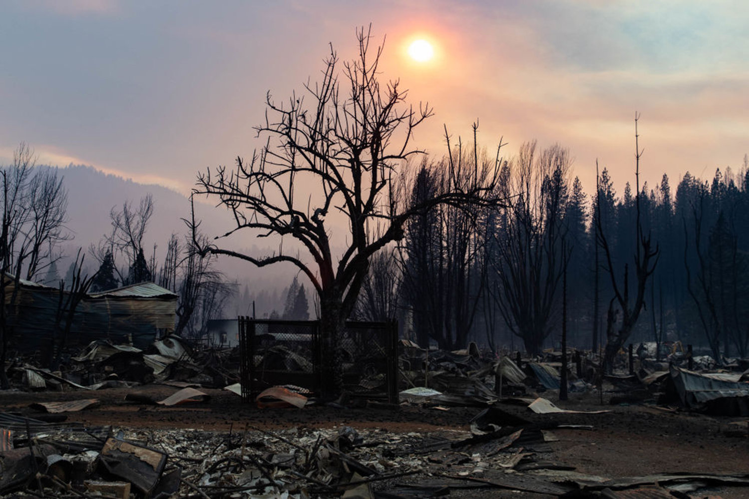 The sun sets on the remains of the town of Greenville on August 8, 2021 in Greenville, California. The Dixie Fire, which has incinerated more than 463,000 acres, is the second largest recorded wildfire in state history and remains only 21 percent contained. (Maranie R. Staab/Getty Images/TNS)