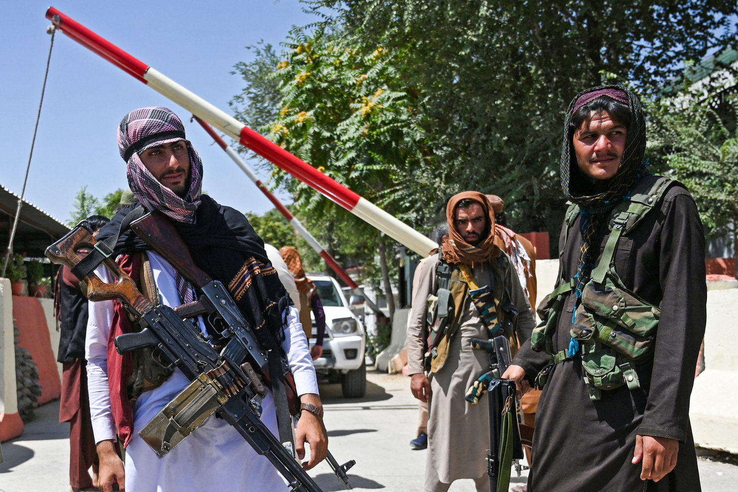Taliban fighters stand guard along a roadside near the Zanbaq Square in Kabul on August 16, 2021, after a stunningly swift end to Afghanistan's 20-year war, as thousands of people mobbed the city's airport trying to flee the group's feared hardline brand of Islamist rule. (Wakil Kohsar/AFP via Getty Images/TNS)