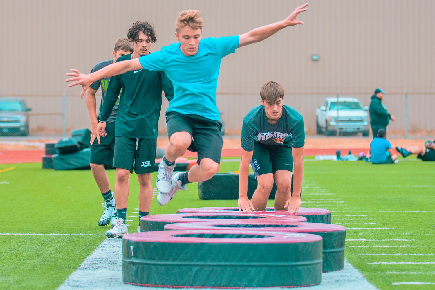 Centralia sophomore Kellen Rooklidge jumps through tires during a drill on the opening day of football practice Wednesday.