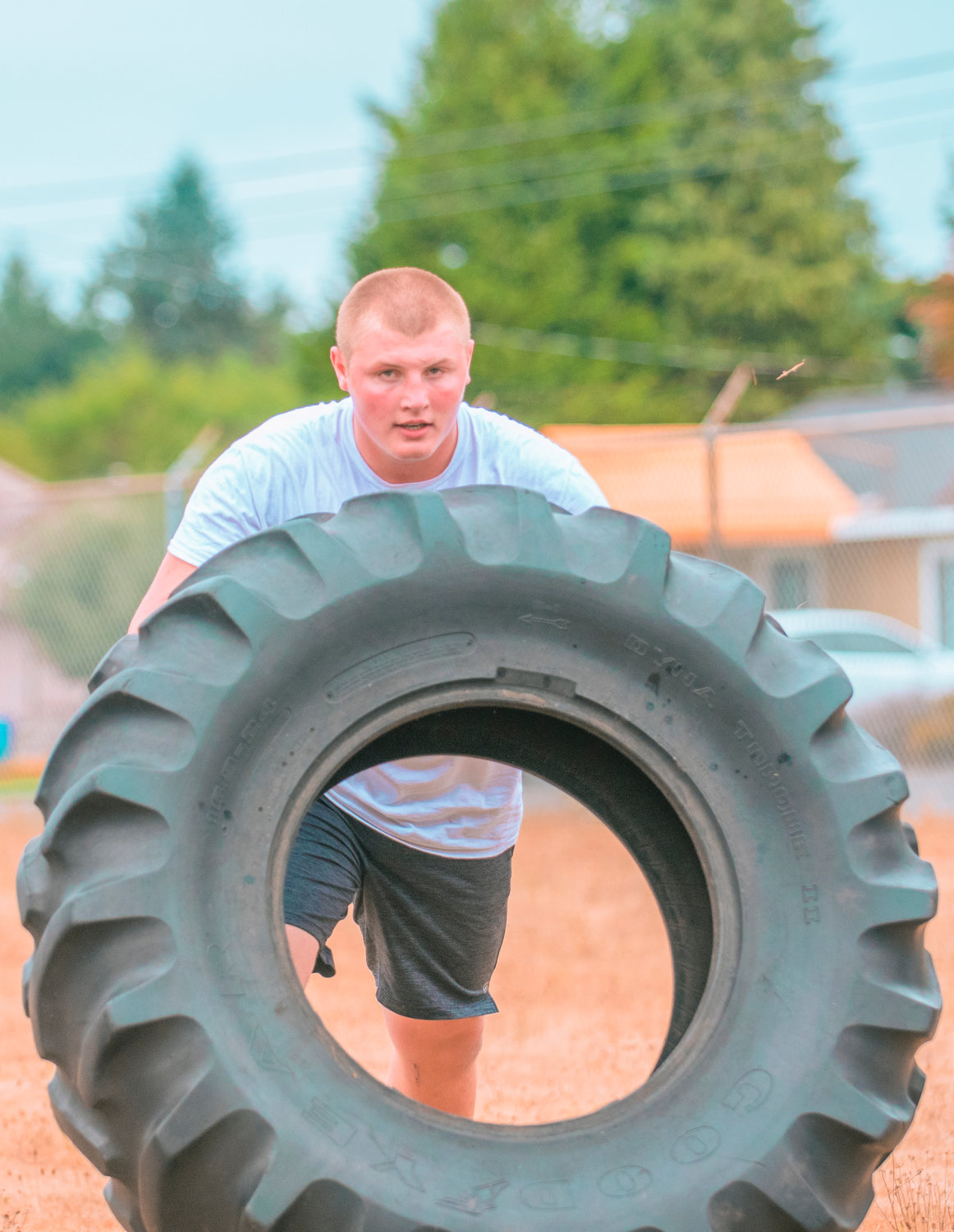 Centralia junior lineman Willie Stinkeoway flips tires during the first day of football practice on Wednesday.