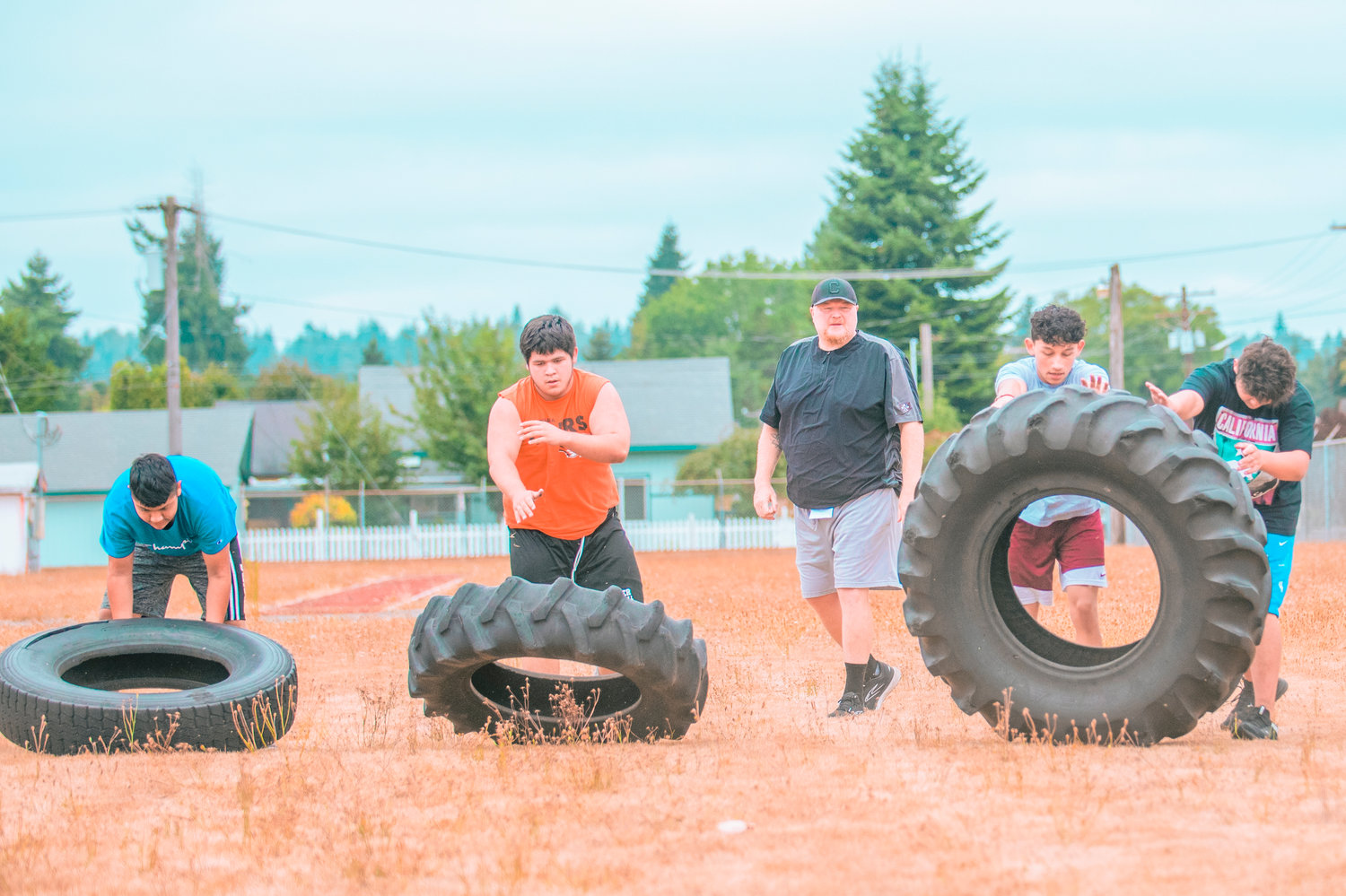 Centralia football players flip tires during the first day of football practice on Wednesday.
