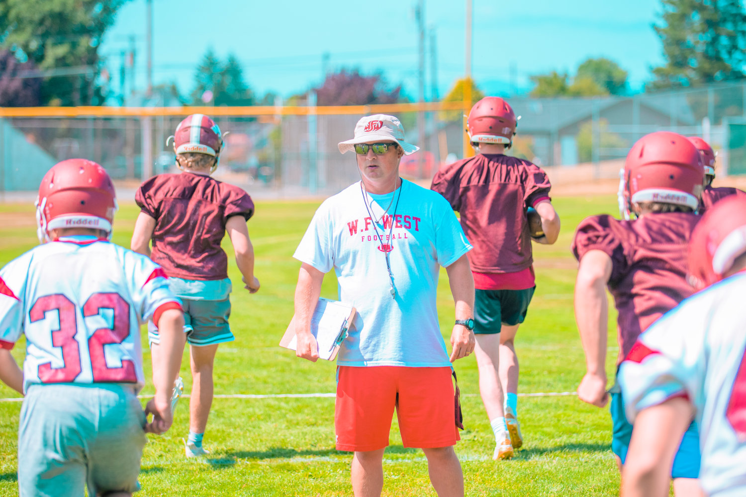 W.F. West football coach Dan Hill watches his team run drills during the opening day of practice on Wednesday.
