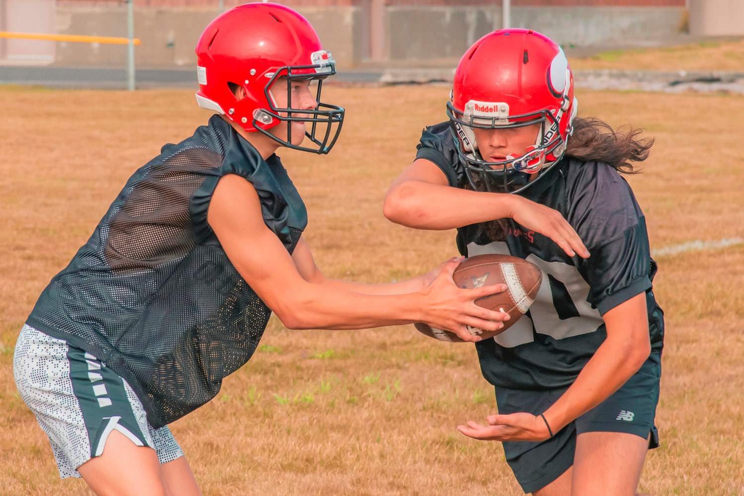 Mossyrock’s Sage Greisen receives a hand off during football practice Wednesday afternoon.