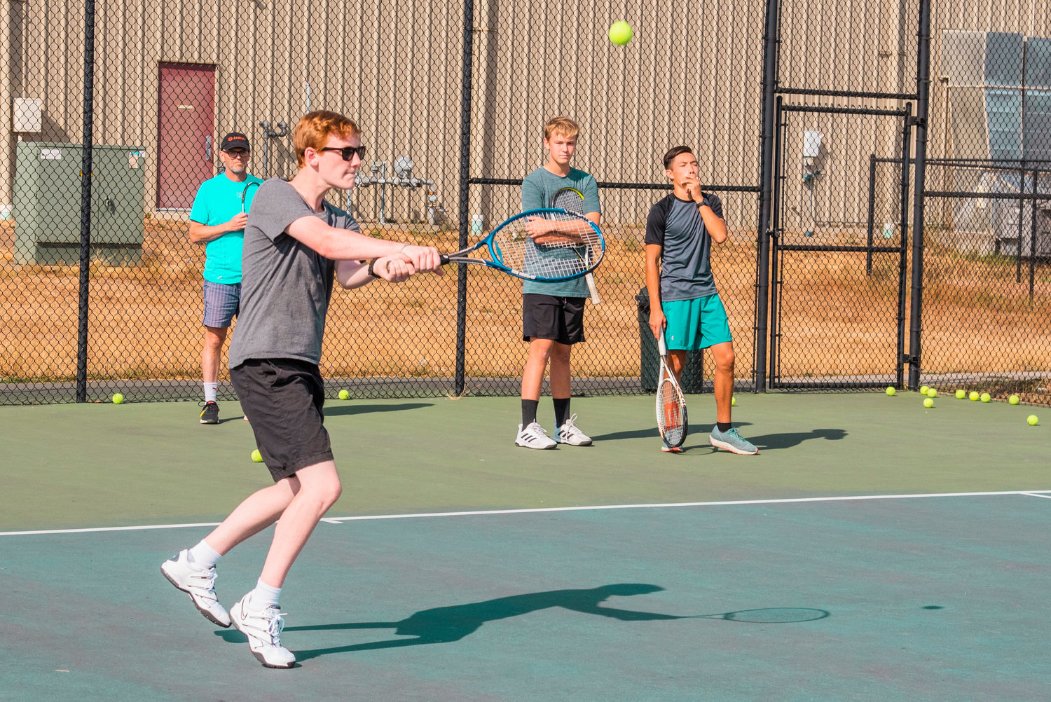 Players work on ball return during tennis practice near Tiger Stadium in Centralia on Tuesday.