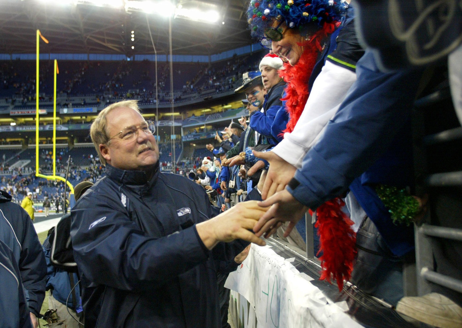 Seattle Seahawks coach Mike Holmgren takes time to congratulate the fans following a 28-10 win over the Arizona Cardinals at Seahawks Stadium in Seattle on December 21, 2003..