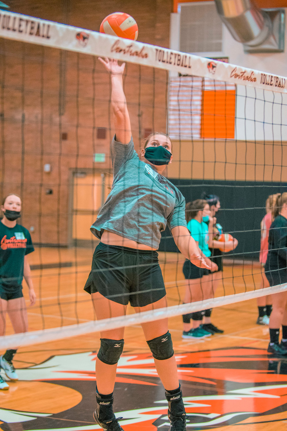 Centralia's Emily Wilkerson leaps for a ball at the net during practice on Tuesday.