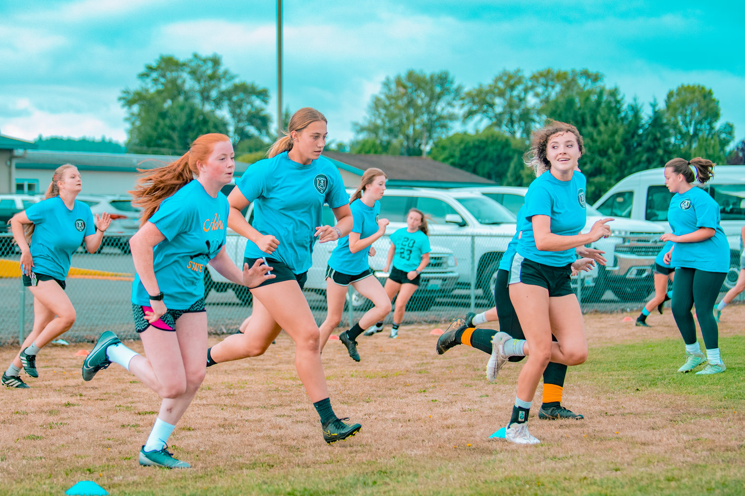 Adna girls soccer players sprint through the opening drills of Thursday's practice.