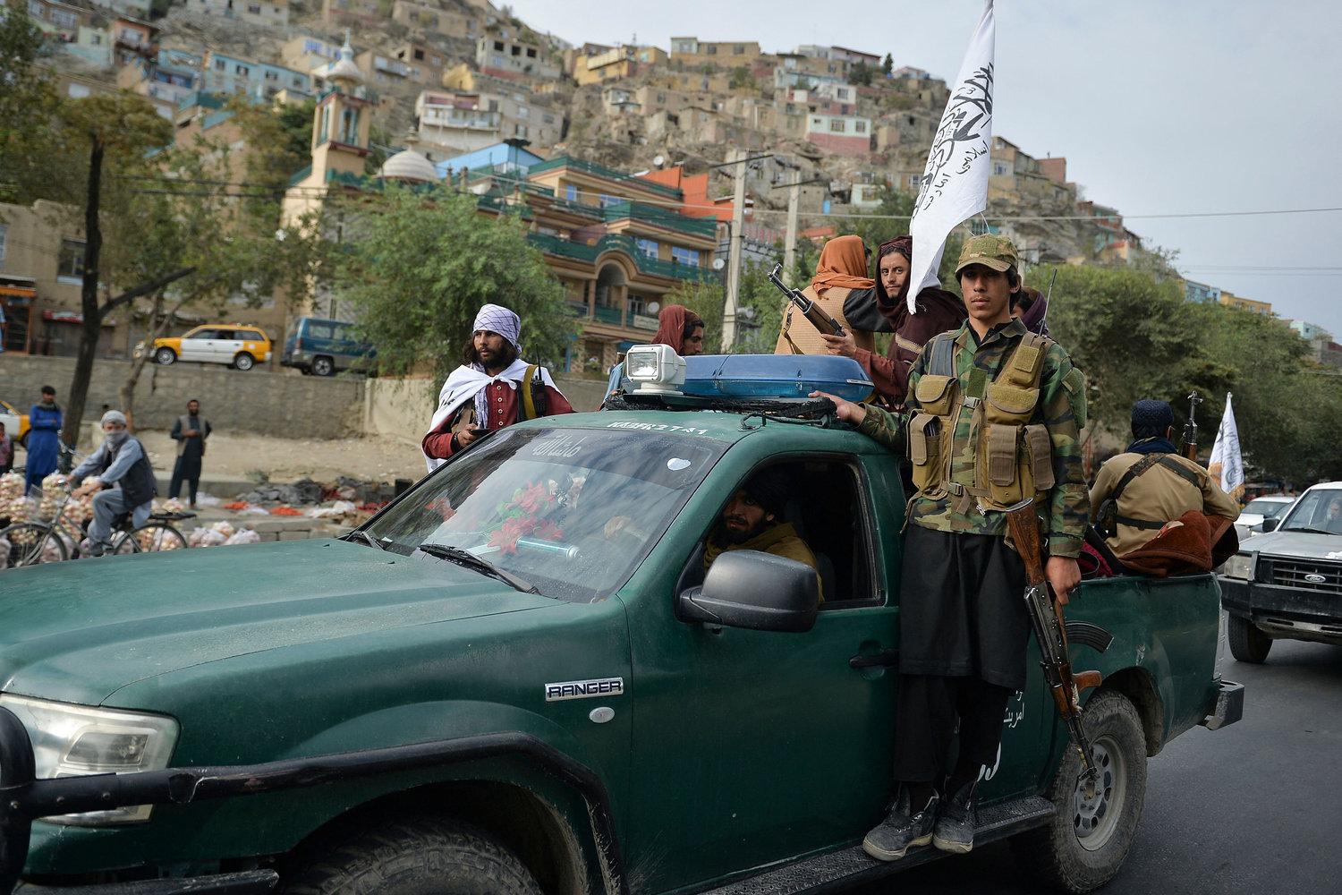 Taliban fighters on a pick-up vehicle take part in a rally in Kabul on August 31, 2021 as they celebrate after the U.S. pulled all its troops out of the country to end a brutal 20-year war -- one that started and ended with the hardline Islamists in power. (Hoshang Hashimi/AFP/Getty Images/TNS)