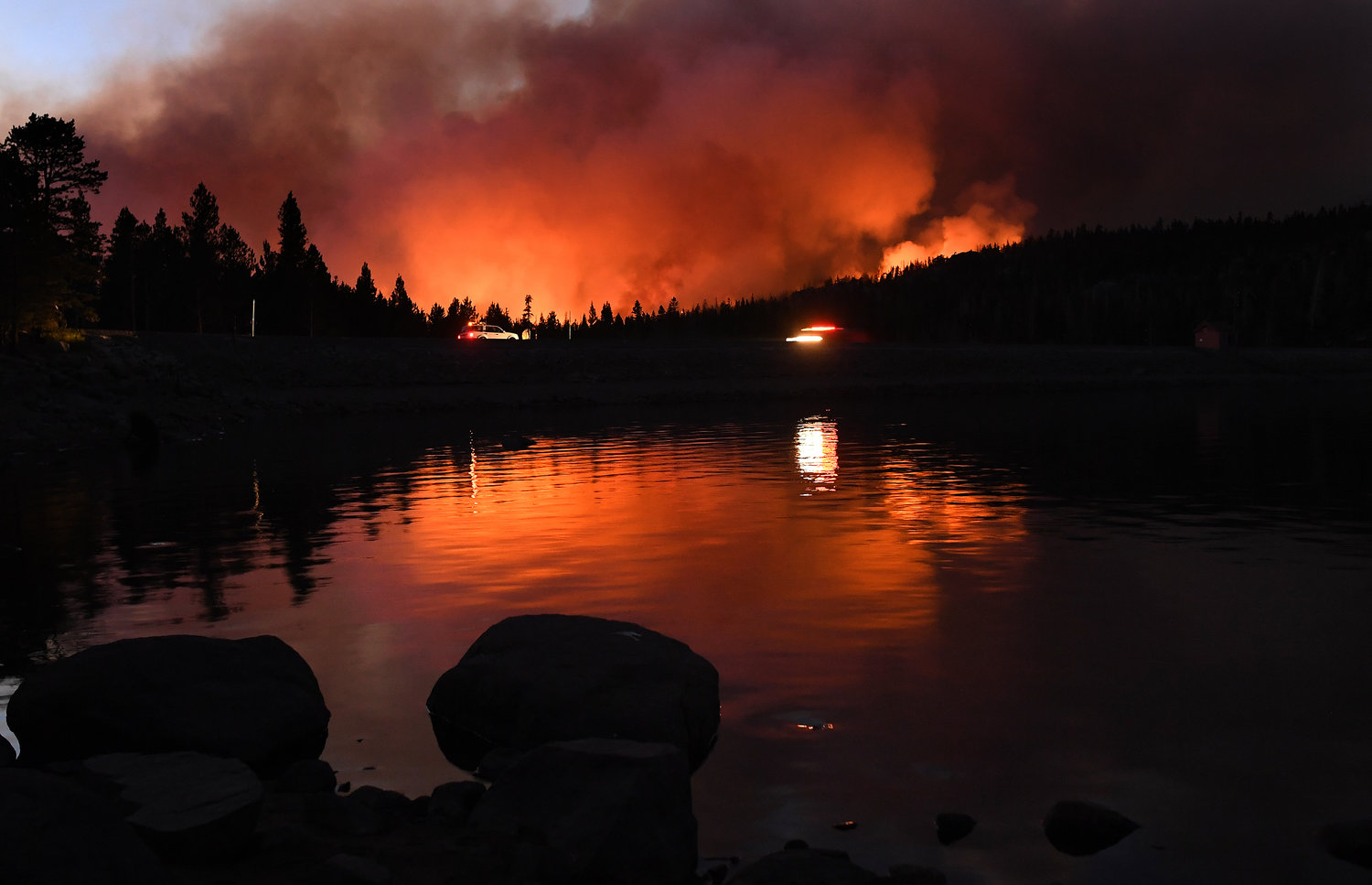 The Caldor fire is reflected off of Caples Lake near the Kirkwood ski resort Wednesday, September 1, 2021 in Lake Tahoe, California. (Wally Skalij/Los Angeles Times/TNS)