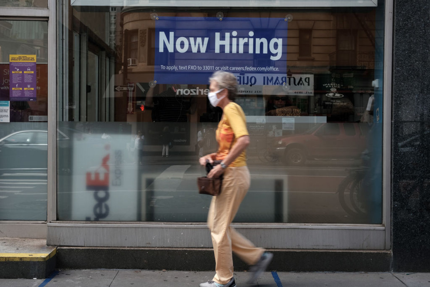 A hiring sign is displayed in a store window in Manhattan on August 19, 2021 in New York City. (Spencer Platt/Getty Images/TNS)