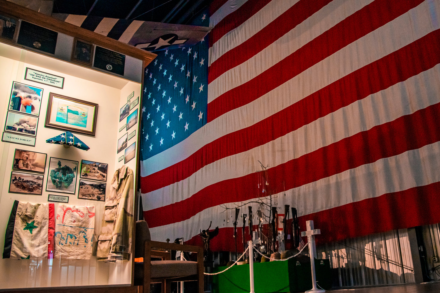 A display case that highlights details of September 11, 2001 is illuminated inside the Veterans Memorial Museum Thursday afternoon in Chehalis as an American Flag sets the backdrop.