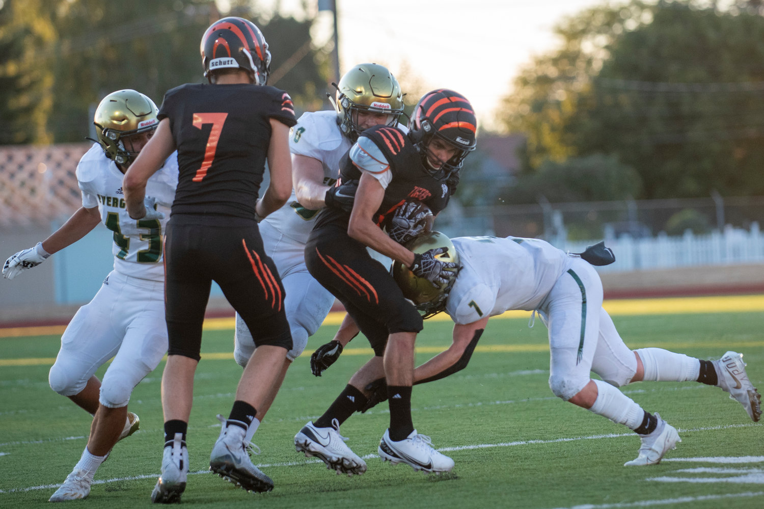 A Centralia ballcarrier is brought down by two Evergreen defenders on Friday, Sept. 3 in Centralia.