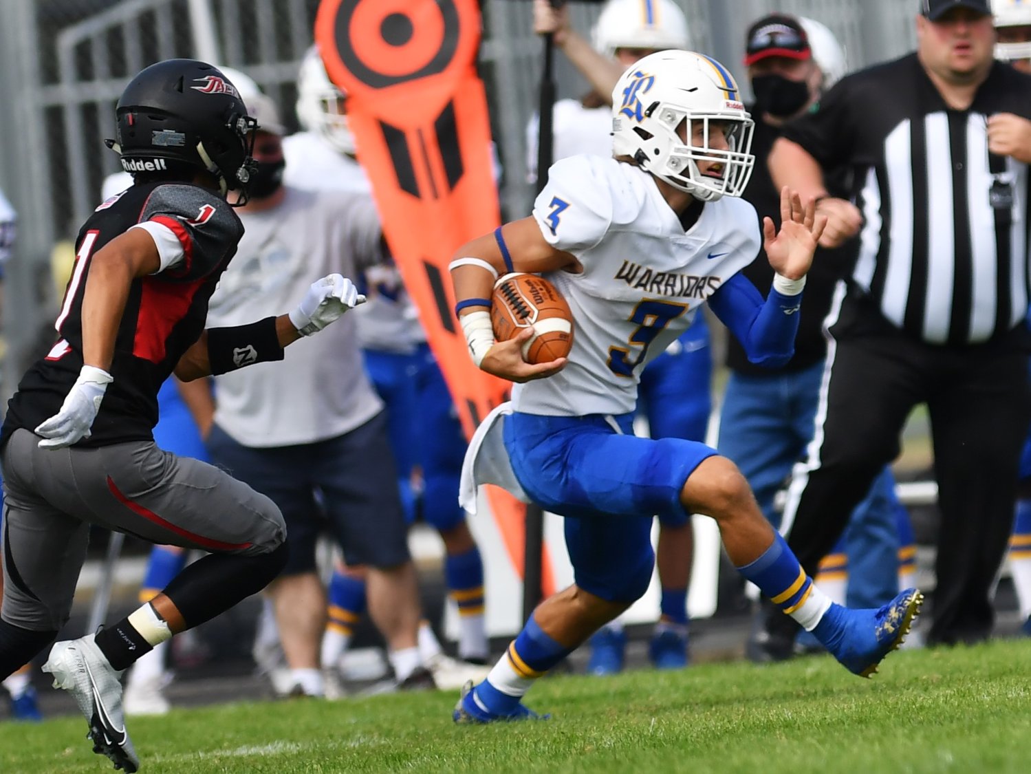 Rochester tailback Talon Betts flies past an R.A. Long defender near the sideline on Saturday during the Warriors' 42-20 victory.