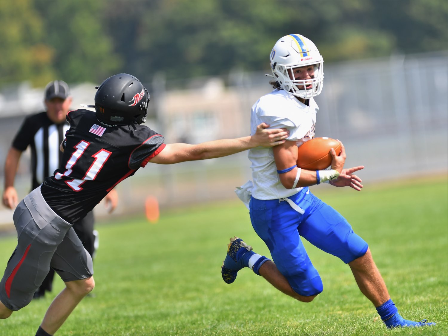Rochester tailback Talon Betts evades an R.A. Long defender during the Warriors' season opener Saturday.