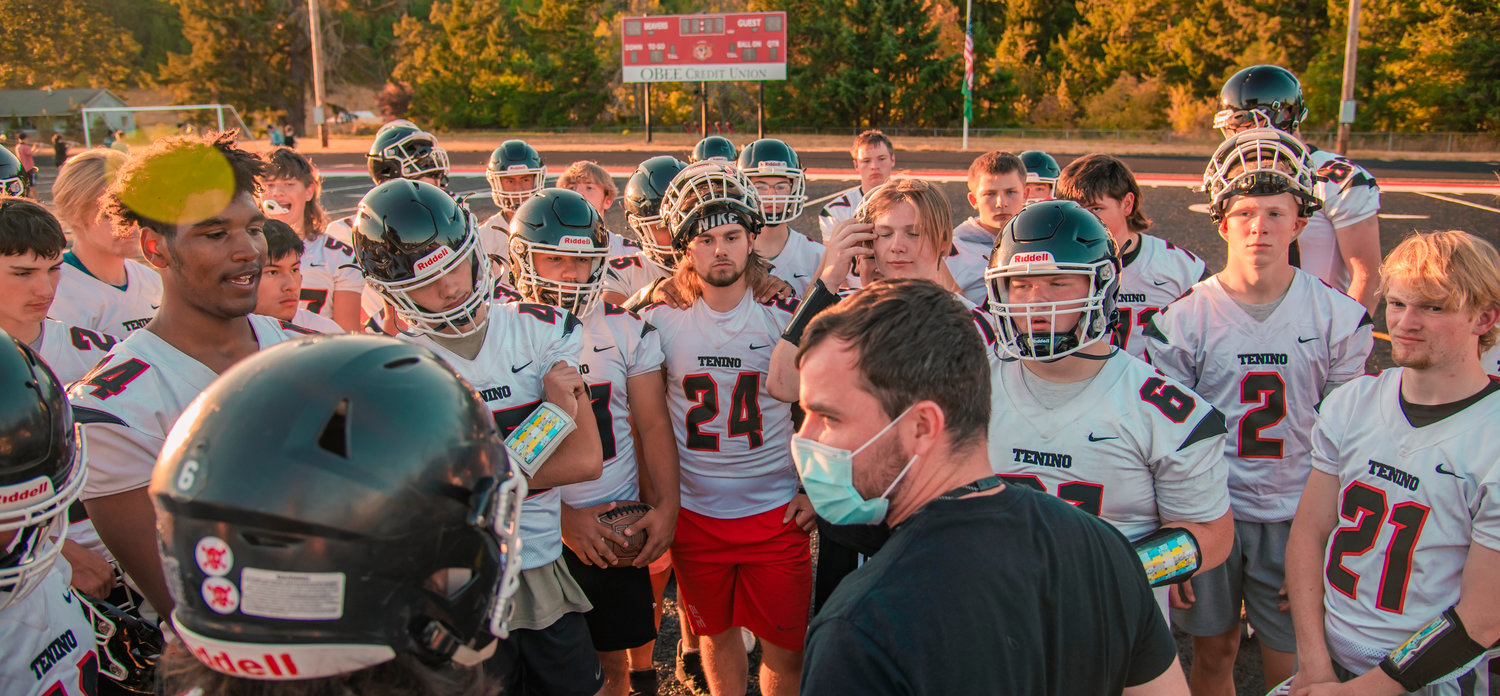Tenino football players huddle up and listen to their coach during practice Thursday evening at Beaver Stadium.