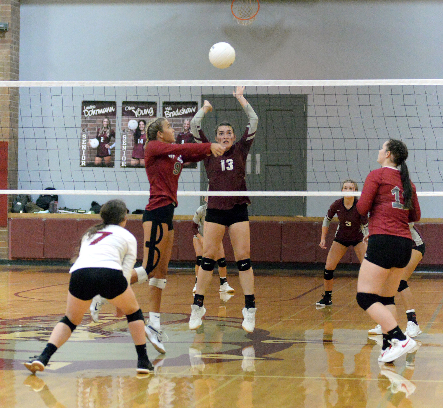 WF West's Ava Olsen gets a shot over the net while Montesano's Addie Winter (13) defends in the Bearcats' 3-2 loss on Tuesday at Bo Griffin Memorial Gymnasium in Montesano.
