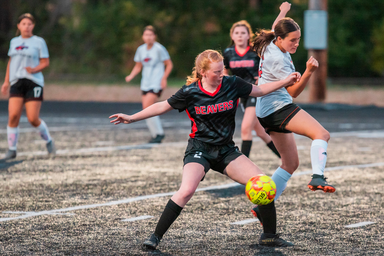 Tenino’s Abby Severse (2) fights for possession before taking the ball down to score Tuesday night at Beaver Stadium during a game against Centralia.