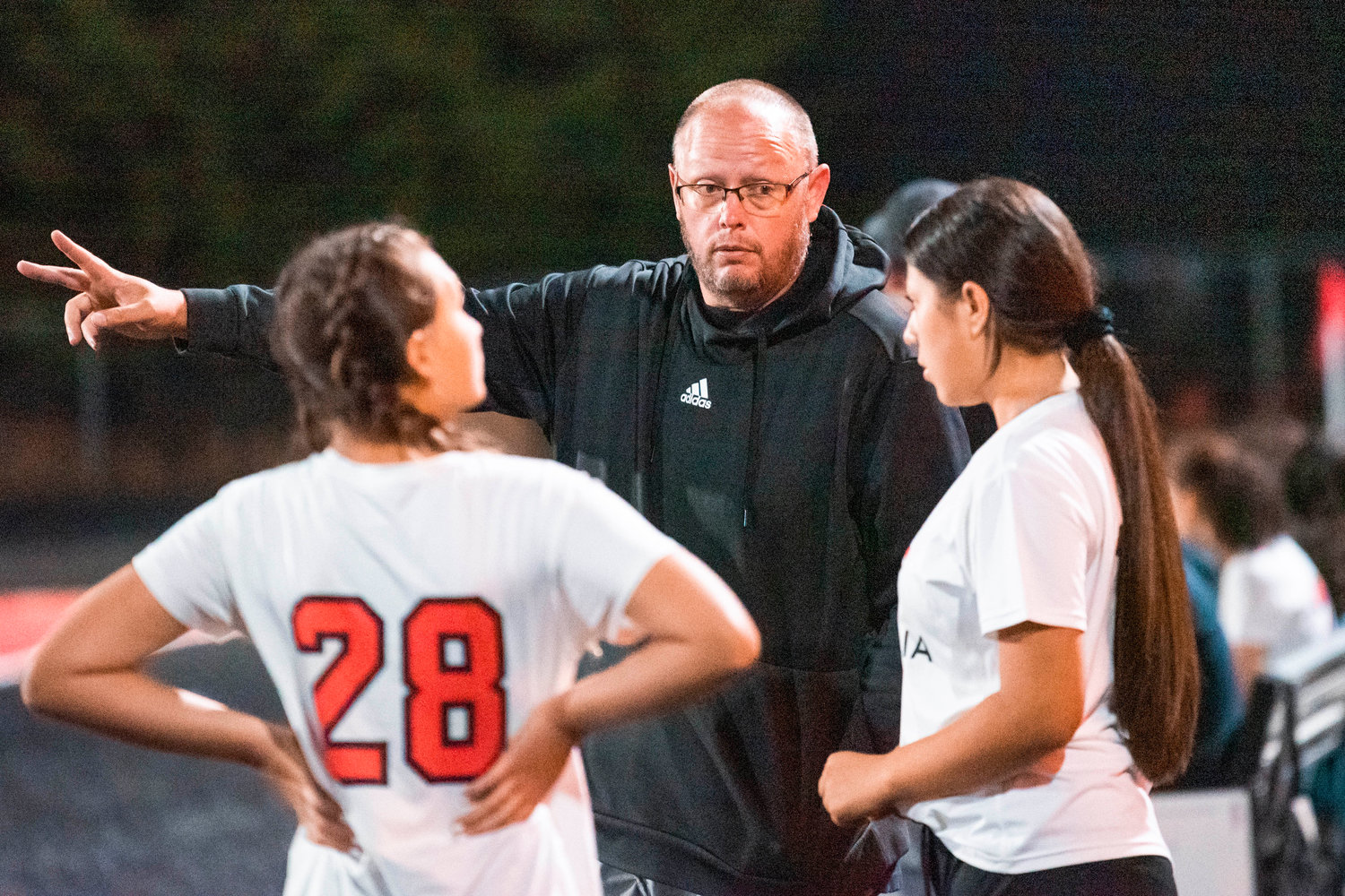 Centralia’s Head Coach Henry Gallanger talks to players Tuesday night at Beaver Stadium during a game against Tenino.