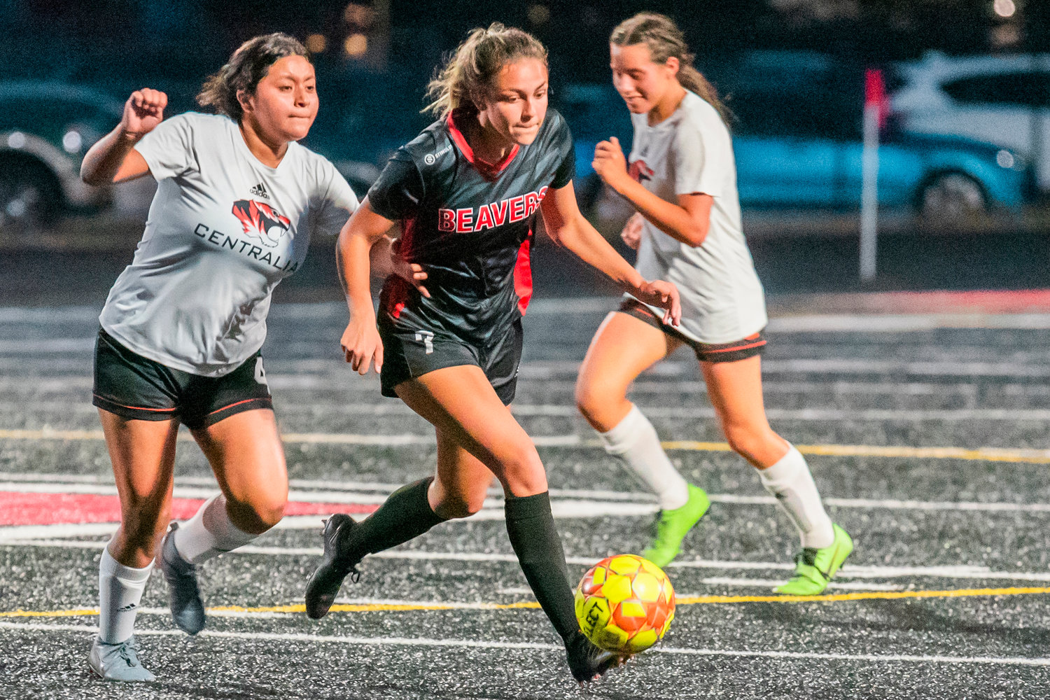 Tenino’s Emma Barr (7) weaves through defenders at Beaver Stadium Tuesday night during a game against Centralia.