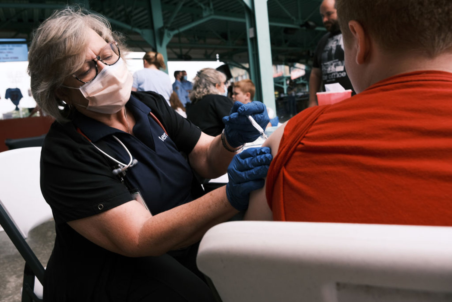 A nurse administers the COVID-19 vaccine to a teen at a baseball game on August 5, 2021 in Springfield, Missouri. (Spencer Platt/Getty Images/TNS)