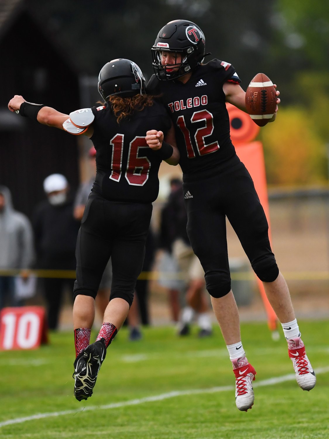 Carson Olmstead (12) celebrates his touchdown with teammate Zane Raney (16) on Friday.