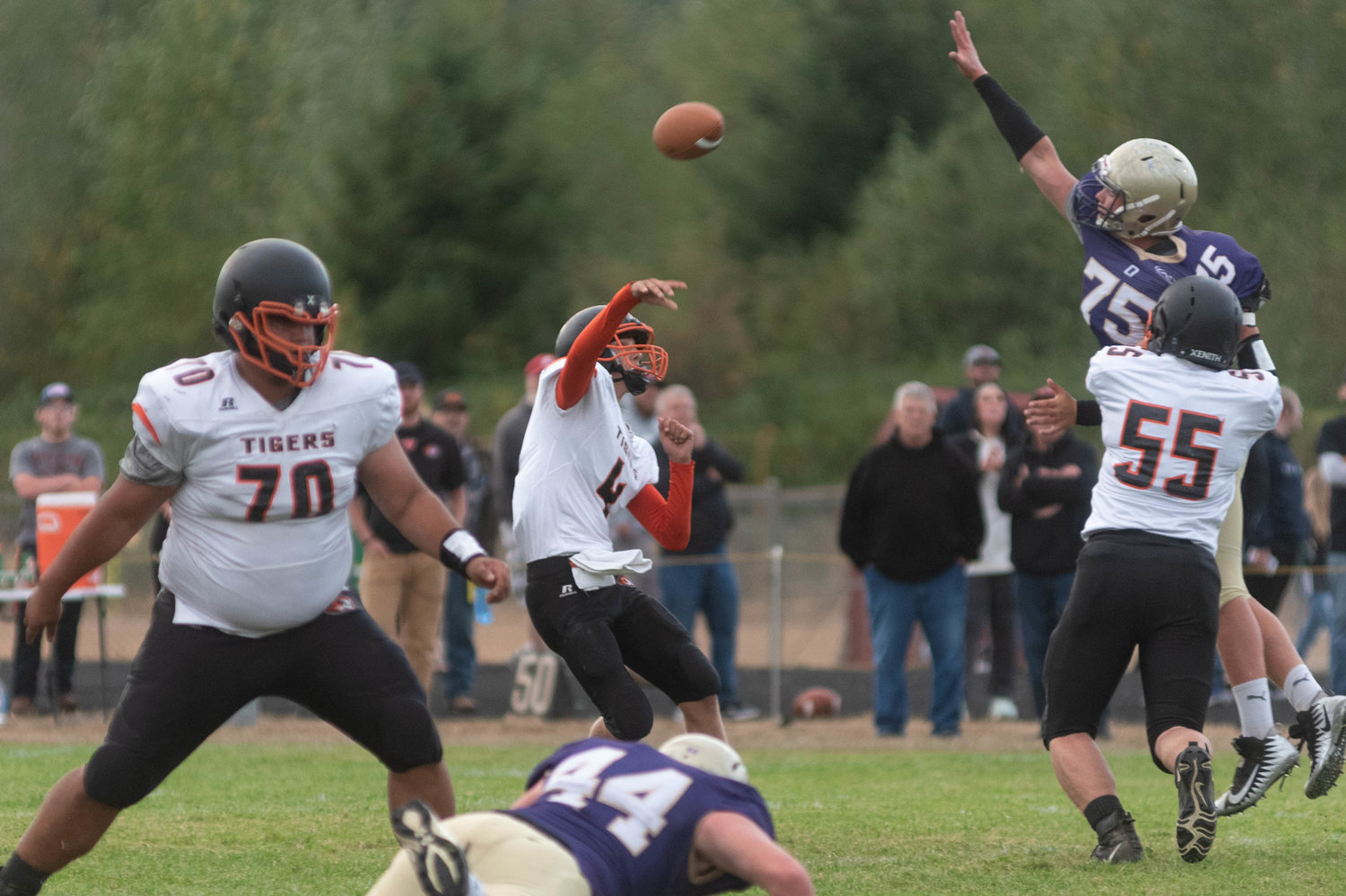 Sophomore Napavine quarterback Ashton Demarest lobs a pass over the outstretched arms of a defender in the Tigers 34-20 win over Onalaska Friday night.