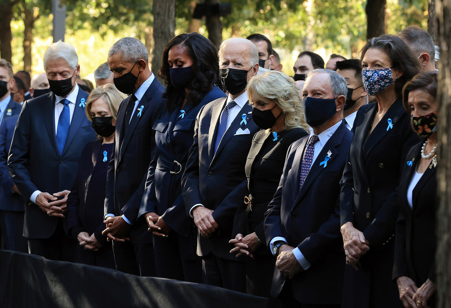 From left, former President Bill Clinton, former Secretary of State Hillary Clinton, former President Barack Obama, former first lady Michelle Obama, President Joe Biden, first lady Jill Biden, former New York City Mayor Michael Bloomberg, Bloomberg's partner Diana Taylor and Speaker of the House Nancy Pelosi (D-CA) participate in a moment of silence during the annual 9/11 Commemoration Ceremony at the National 9/11 Memorial and Museum on Saturday, Sept. 11, 2021, in New York City. (Chip Somodevilla/Getty Images/TNS)