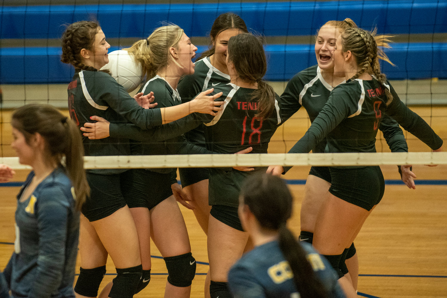 Tenino players celebrate scoring a point against Naselle on Saturday.