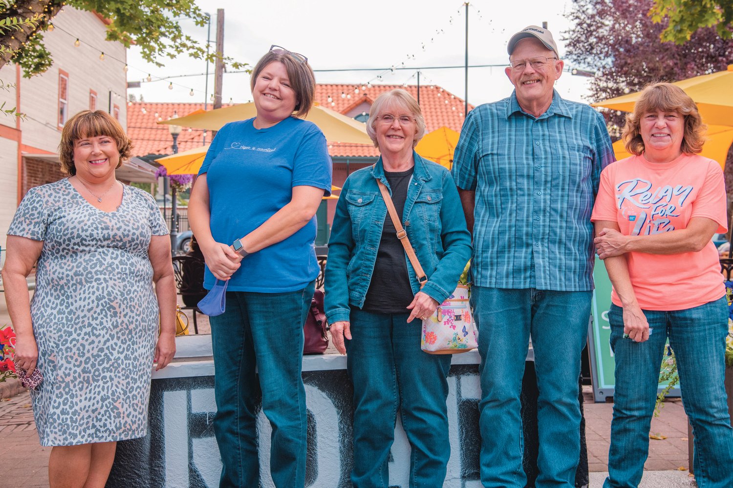 From left, cancer survivors Patty Powell, Jeannine Kelley and Katie Foss along with her husband John Foss and Patty Allee, Relay for Life co-lead organizer, smile and pose for a photo in Centralia on Thursday.