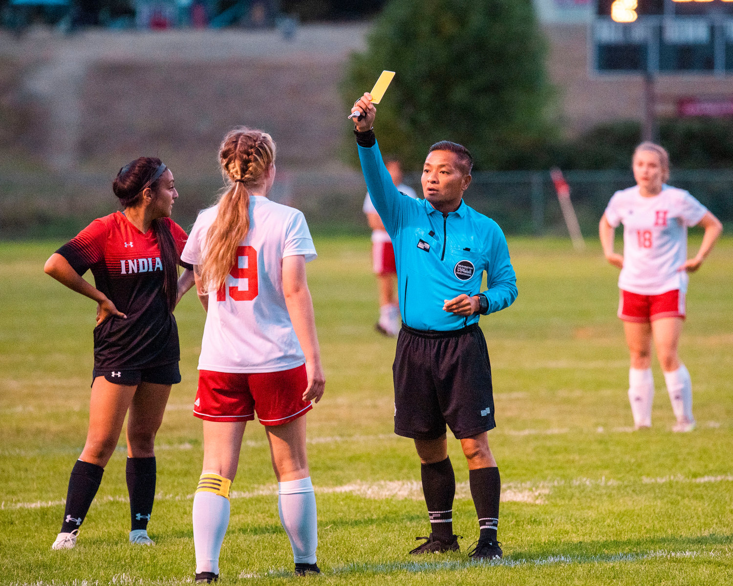 Yellow cards are given out to Hoquiam’s Emma Johnson (19) and Toledo’s Briza Gallegos (4) during a game Tuesday night.