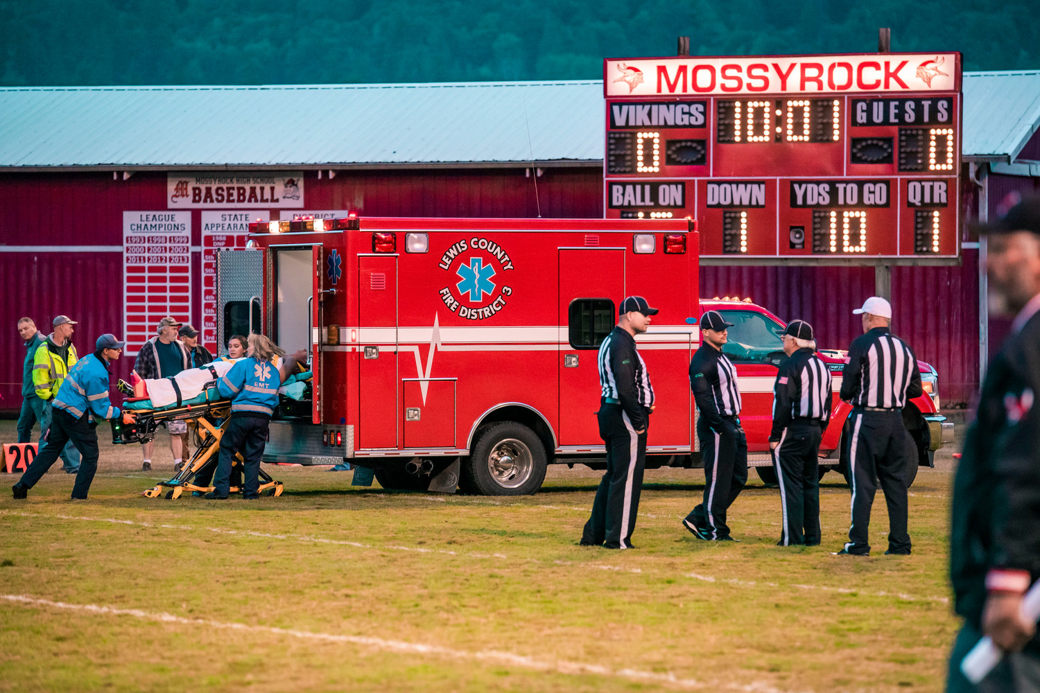 Mossyrock senior Gunner Mulligan is loaded into an ambulance following a leg injury Friday night during a football game against Charles Wright Academy.