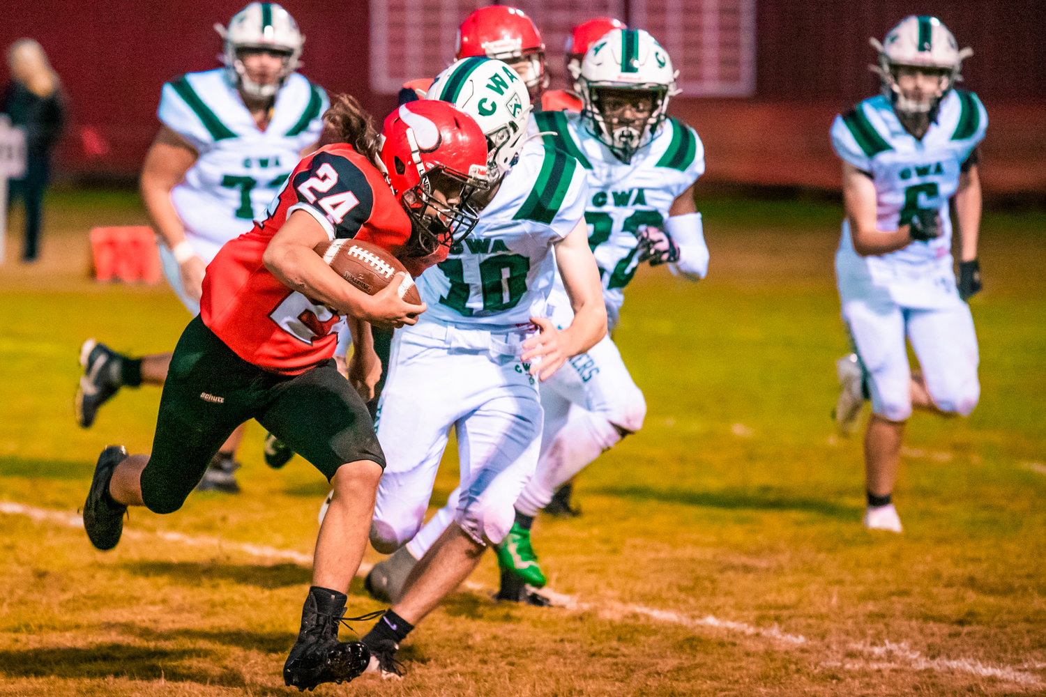 Mossyrock’s Sage Greisen (24) runs past defenders with the football during a home game Friday night.