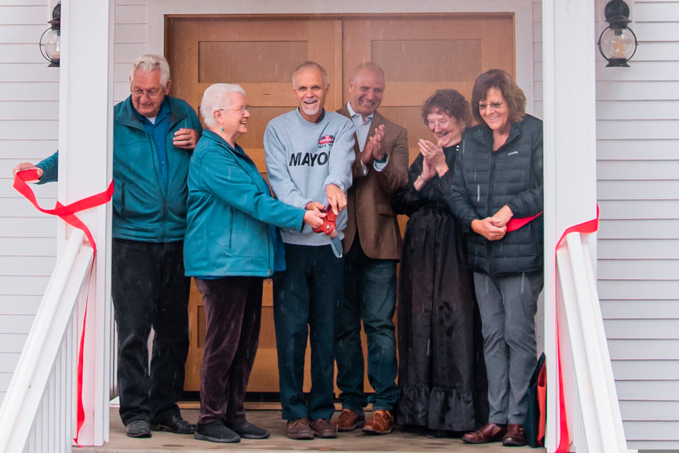 From left, Lee Coumbs, Bonnie Canaday, Centralia Mayor Max Vogt, state Rep. Peter Abbarno, Jean Bluhm and Centralia City Councilor Sue Luond stand on the steps of the pioneer church during a ribbon cutting ceremony Saturday.