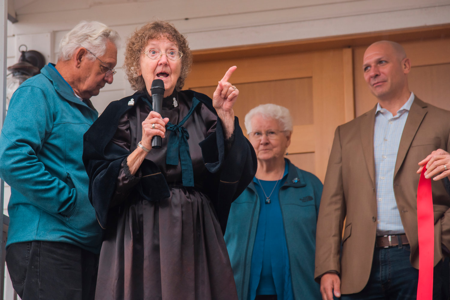Jean Bluhm talks to attendees of a ribbon cutting ceremony for the Borst Park Pioneer Church in Centralia on Saturday.