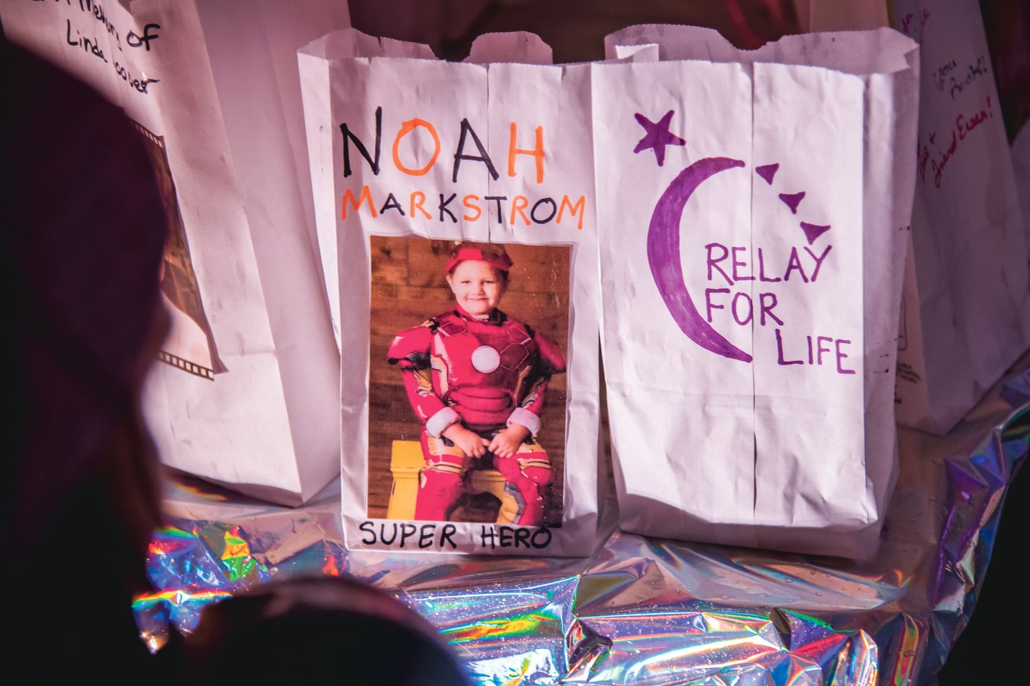 A memorial for Noah Markstrom is displayed during a Relay For Life Luminaria at George Washington Park in Centralia Saturday night.