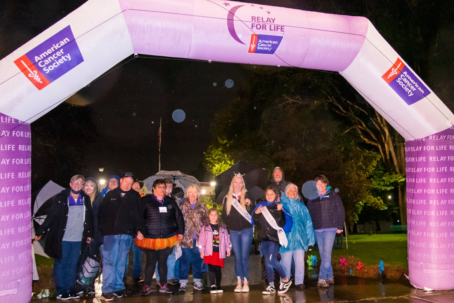 Community members pose under a Relay For Life archway at George Washington Park in Centralia Saturday night.