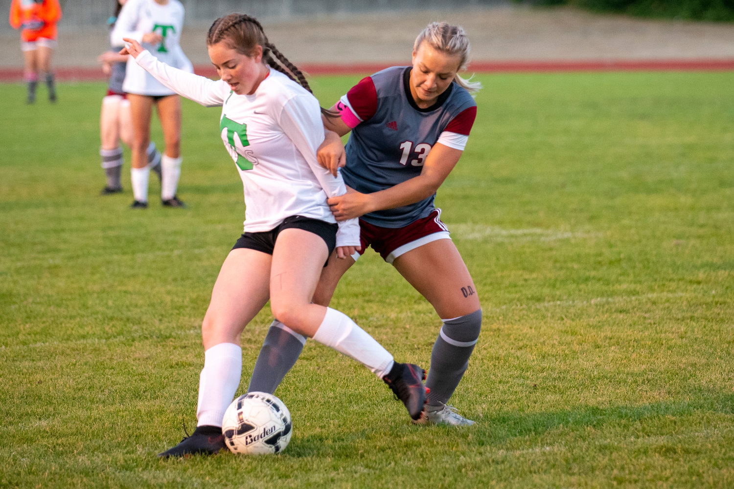 W.F. West's Cameron Sheets (13) battles for the ball against Tumwater's Olivia Kee on Tuesday.