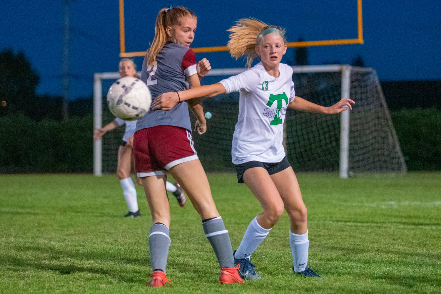 Tumwater's Lucy Bergford (13) knocks the ball past W.F. West's Maddy Casper (2) on Tuesday in Chehalis.