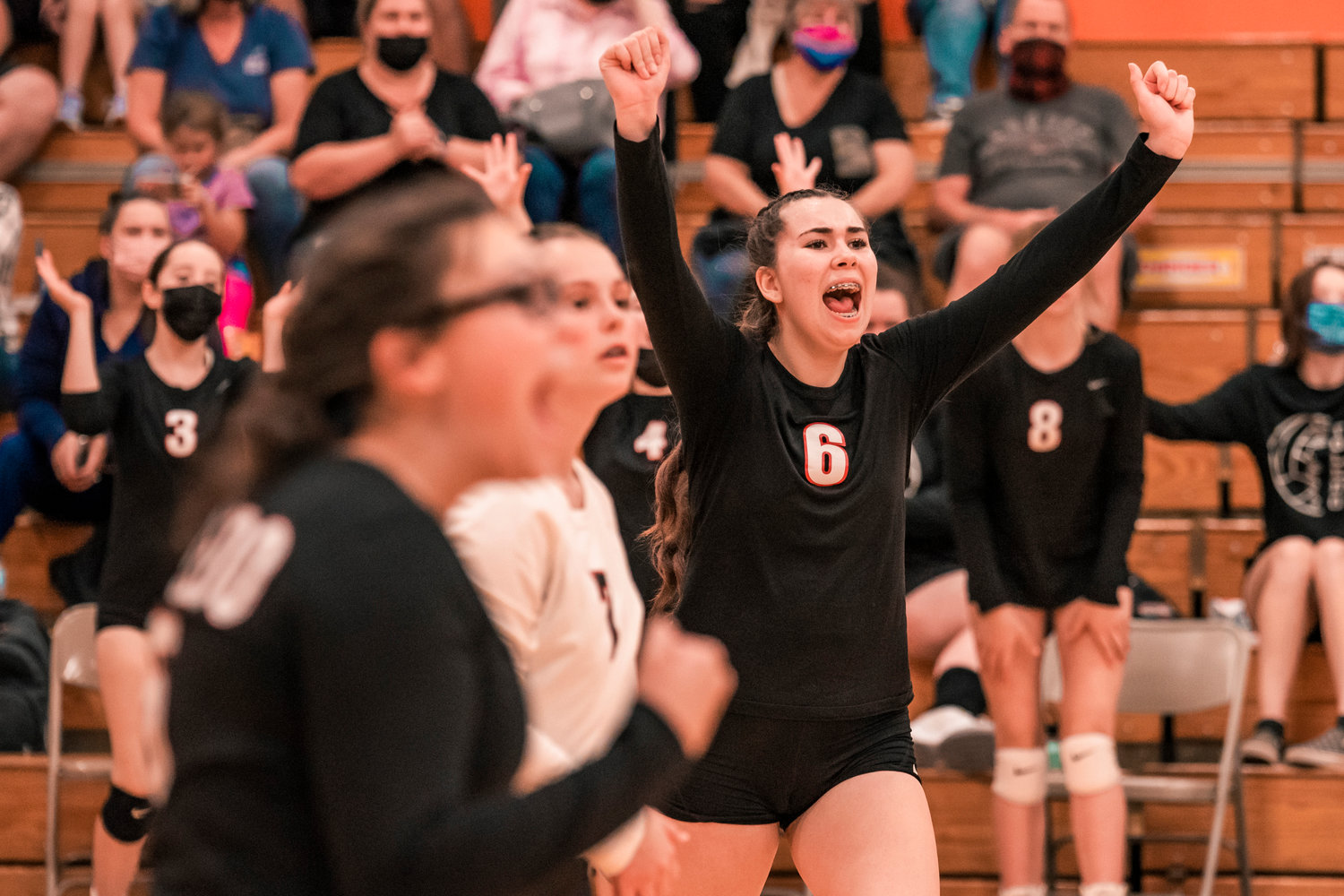 Toledo’s Stefa Arceo-Hansen (6) raises her arms and cheers following a score during a match against Napavine Tuesday night.