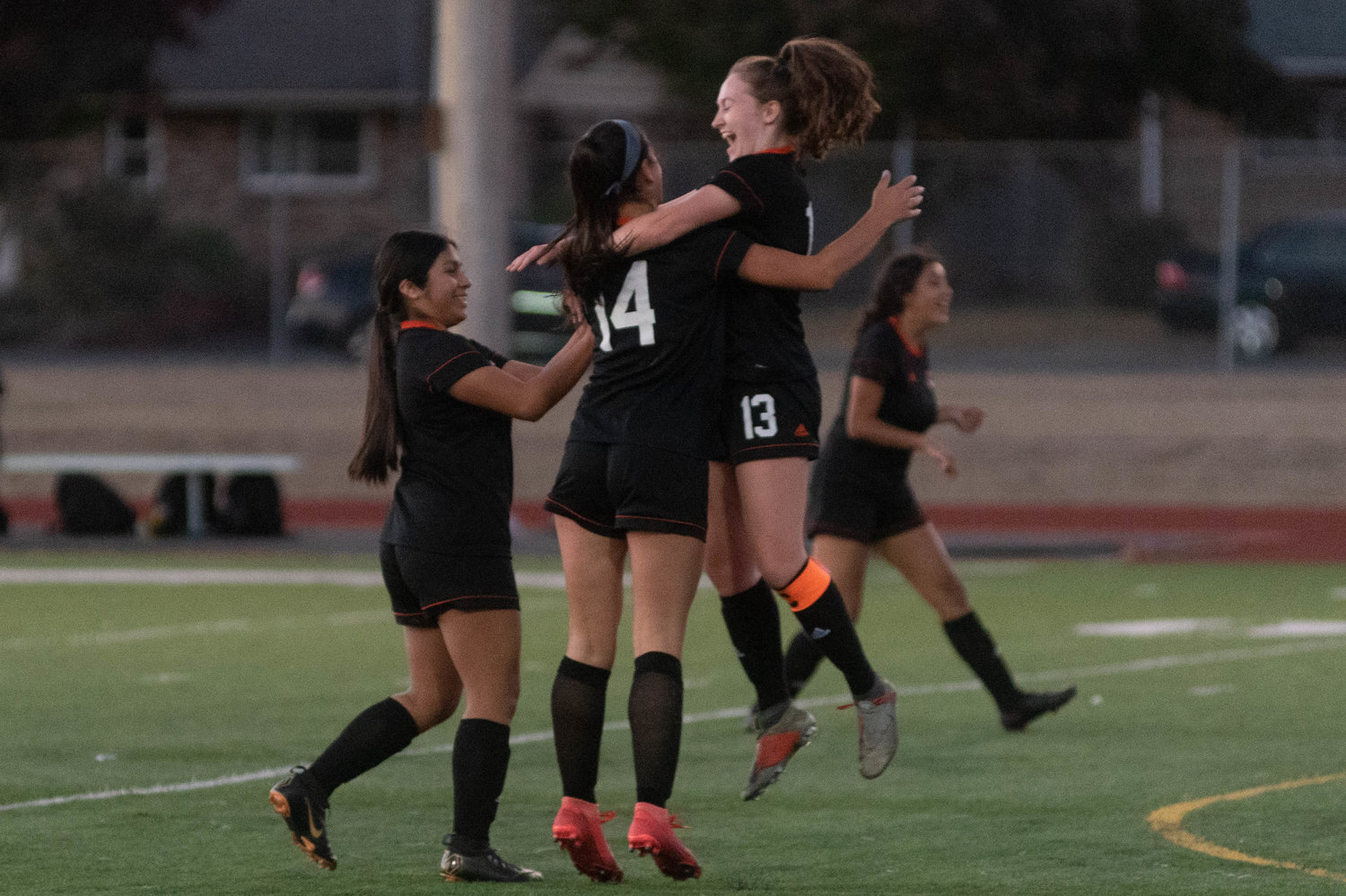Riley Babka (14) celebrates with her team after scoring a goal in the 11th minute in the Tigers loss to Shelton Thursday night.