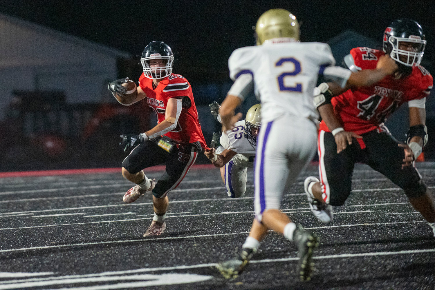 Tenino tailback Dylan Spicer (23) breaks free from Josue Roque's (65) grasp while rushing on Friday.