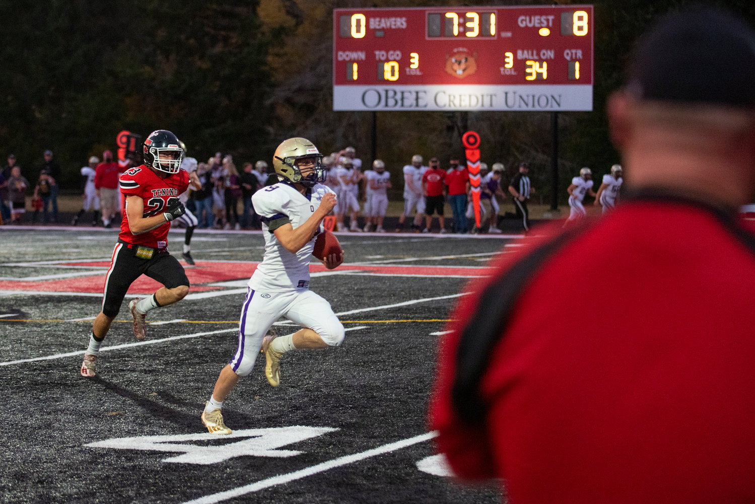 Onalaska's Kolby Mozingo (9) takes off for a 63-yard run before being brought down by Tenino's Dylan Spicer (23) on Friday.