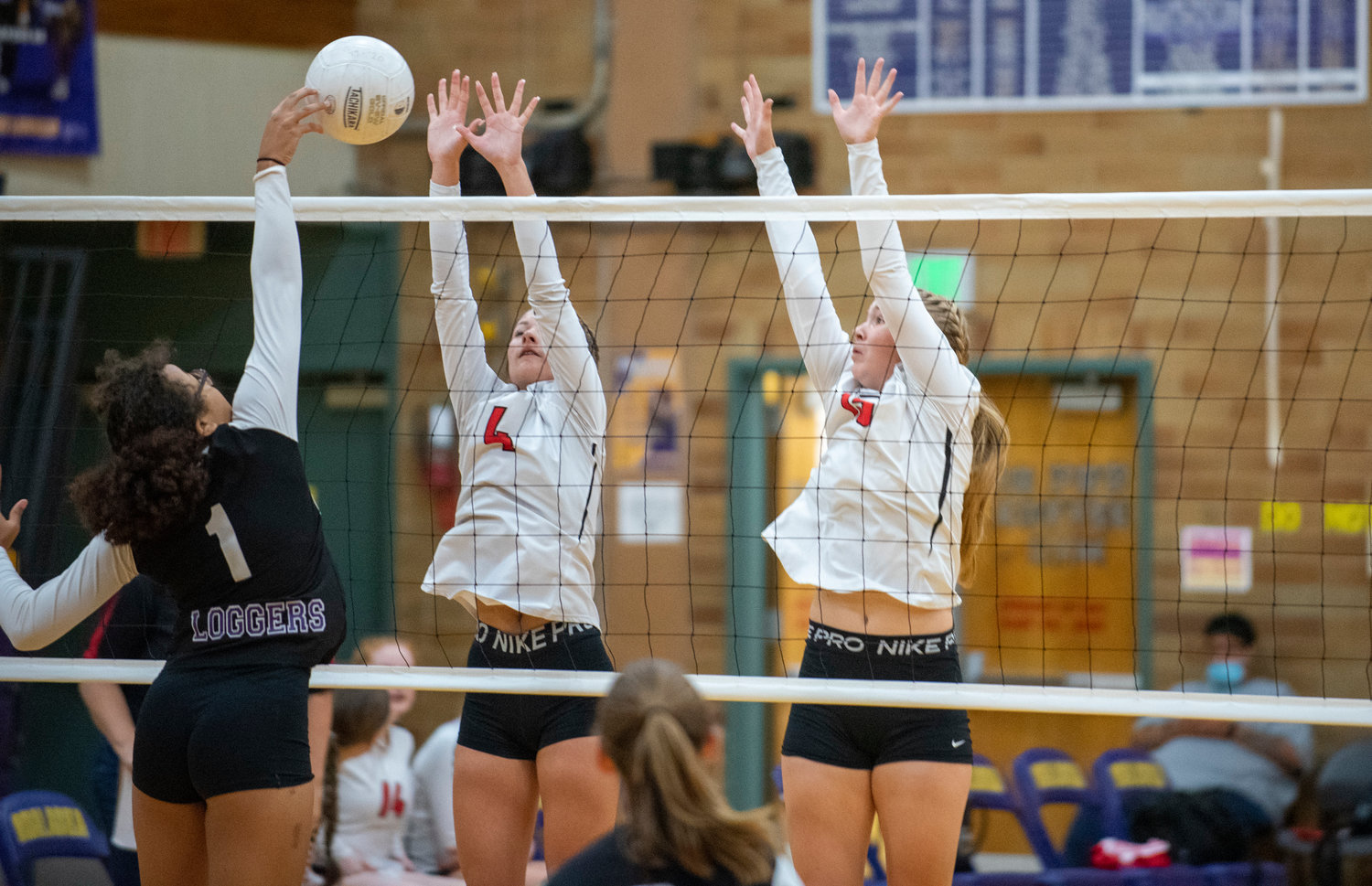 Mossyrock’s Erin Cournyer (4) and Hailey Brooks (15) attempt to block Onalaska’s Jen Lipsey’s (1) block.