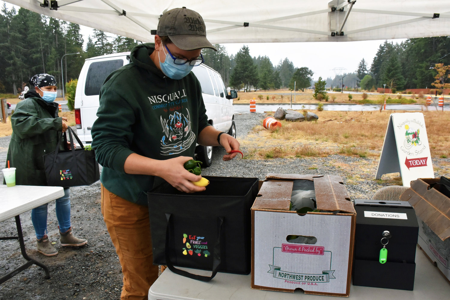 Elsa Haun, the production supervisor for the Nisqually community garden, works the food distribution site near the Nisqually administration building.